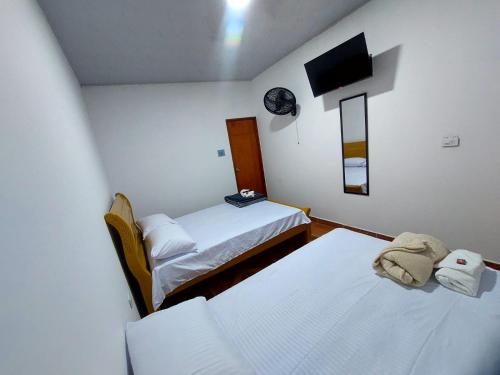 Postel nebo postele na pokoji v ubytování Iku Hotel