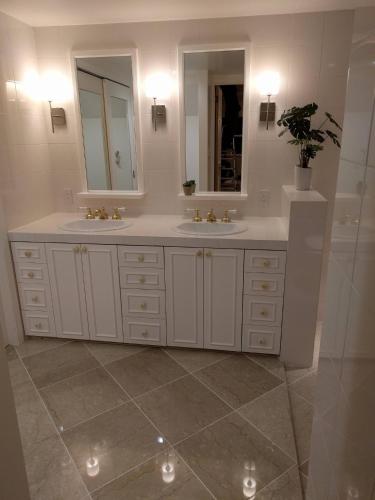 a white bathroom with two sinks and a mirror at Kaeda Terrace - Vacation STAY 69516v in Miyazaki