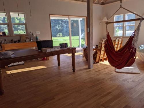a living room with a hammock in the middle of the room at Kaeda Terrace - Vacation STAY 69516v in Miyazaki