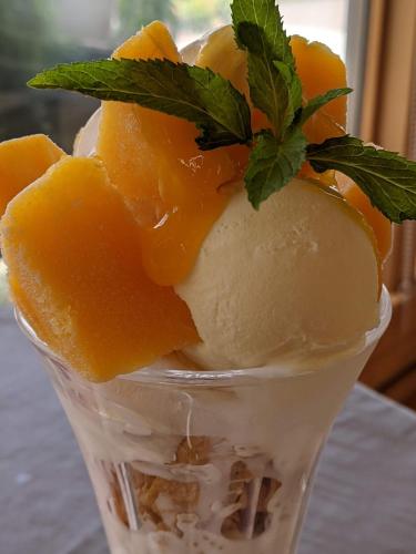a plastic cup filled with ice cream and oranges at Kaeda Terrace - Vacation STAY 69516v in Miyazaki