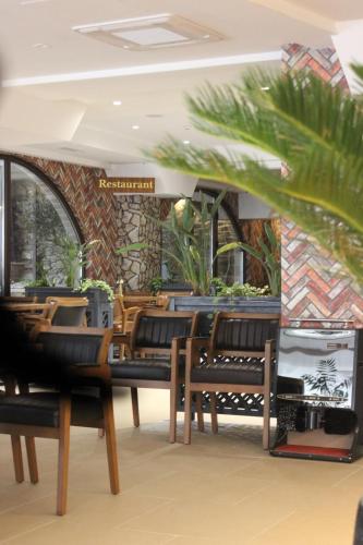 a restaurant with wooden chairs and a stone wall at Old Stone Hotel Skopje in Skopje