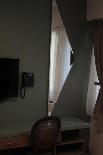 a room with a desk and a window with a phone at Old Stone Hotel Skopje in Skopje