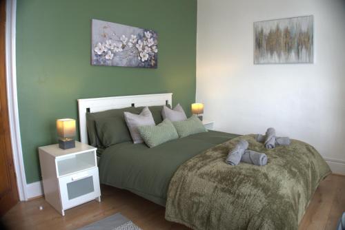 a bedroom with a bed with two teddy bears on it at 3BDR Town House in the Heart of Holyhead - Free Onsite Parking in Holyhead