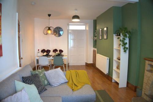 a living room with a couch and a table at 3BDR Town House in the Heart of Holyhead - Free Onsite Parking in Holyhead