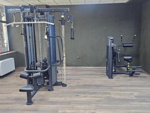 a gym with several tread machines in a room at Grand Chamois Hotel & Spa in Mavrovo