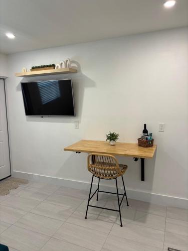 a wooden table and a chair in a room at Cozy tiny home in Cape Coral