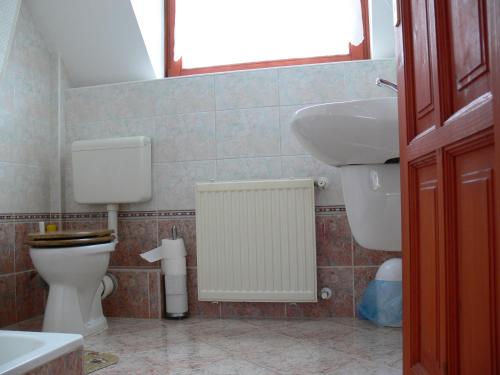uma casa de banho com um WC e um lavatório em St. Michael Apartman em Budapeste
