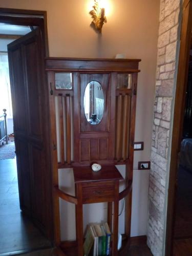 a wooden cabinet with a mirror in a room at Le spighe dei papi in Anagni