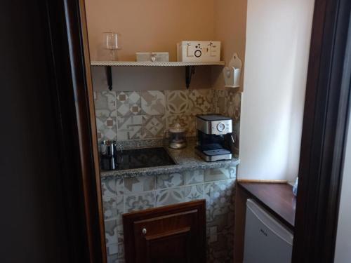 a small kitchen with a sink and a coffee maker at Le spighe dei papi in Anagni