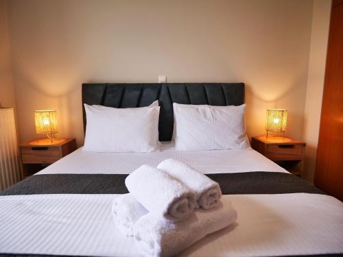 a bedroom with a bed with towels on it at Olive Heaven in Kalamata