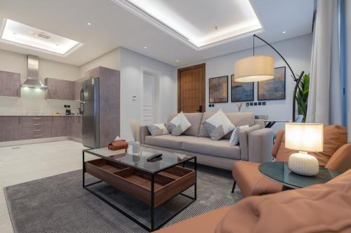 a living room with a couch and a table at أكاريم أفينيوز Akareem Avenues in Riyadh