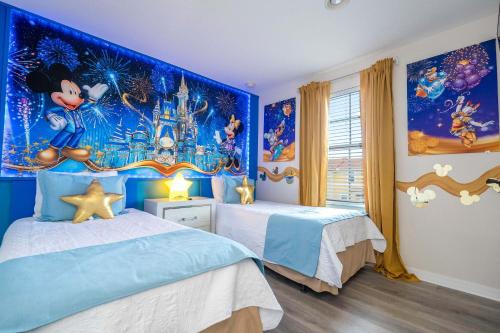 a bedroom with two beds and a disney mural at Three Bedrooms Townhome 3012 in Kissimmee