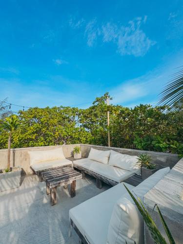 a patio with a couch and a coffee table at Villa Mango Jeri in Jericoacoara