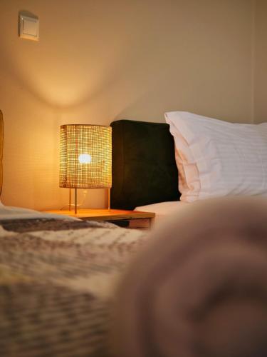 a bedroom with a bed and a lamp on a table at Olive Heaven in Kalamata