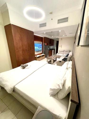 a large bedroom with two beds in a room at Ultra Luxury Chic Studio in JLT in Dubai