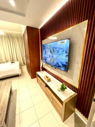 a hotel room with a large flat screen tv on the wall at Ultra Luxury Chic Studio in JLT in Dubai
