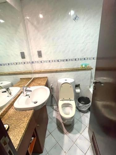 a bathroom with a toilet and a sink at Ultra Luxury Chic Studio in JLT in Dubai