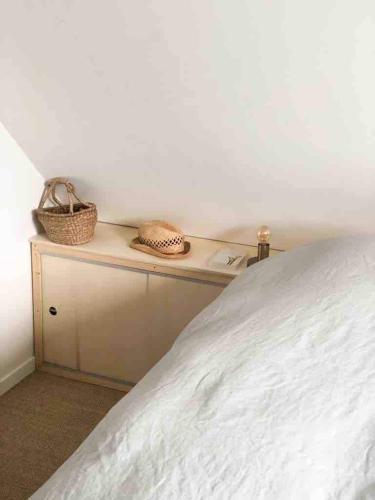 - une chambre avec un lit et une table avec deux paniers dans l'établissement Ma petite maison d hotes - Dunes Cottages - Le Touquet, à Le Touquet-Paris-Plage