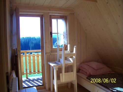 a room with a bed and a ladder in a house at Domek pod Tatrami in Murzasichle