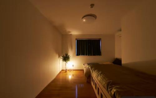 Postel nebo postele na pokoji v ubytování おやど紀伊国屋磨屋町
