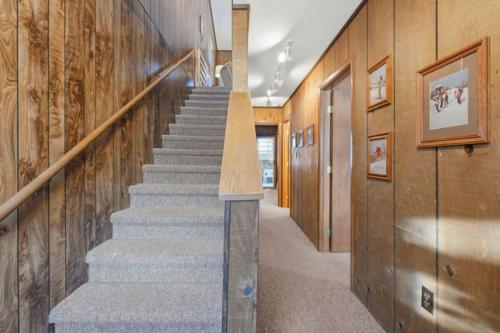 a staircase in a home with wooden walls at Premium Slope-Side Escape I Alpen Villas at Powderhorn Mountain in Bessemer