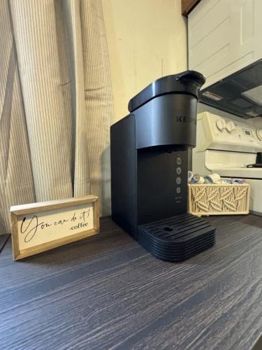 a microwave sitting on a table next to a box at Snowy Escapes at Powderhorn Mountain in Bessemer