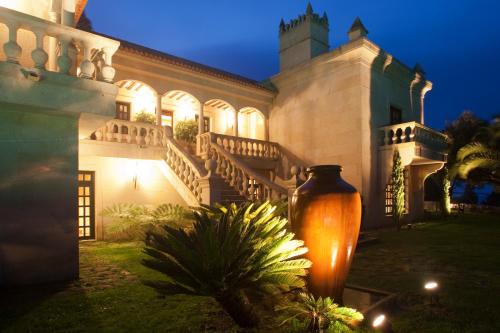 a large building with a large vase in front of it at LUXURY CELAVELLA GALICIA Hc in Baiona