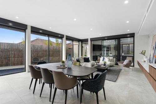 an open living room with a table and chairs at 5 Ensuite Luxury Holiday House Balwyn North in Melbourne