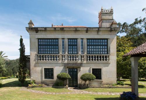 a large stone building with a balcony on top of it at LUXURY CELAVELLA GALICIA Hc in Baiona