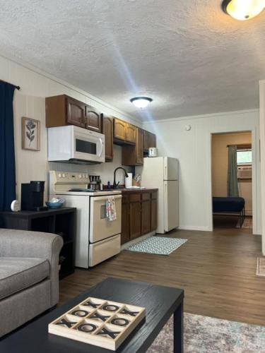 a kitchen and living room with a couch and a table at Elevated Ski Chalet at Powderhorn Mountain in Bessemer