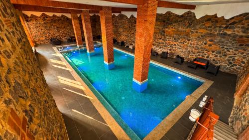 an overhead view of a swimming pool in a building at Le Suisse Spa in Santa Lucía Milpas Altas