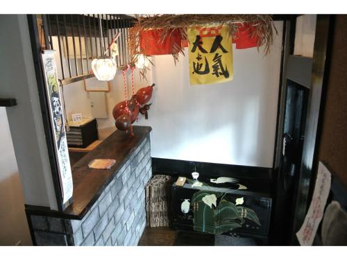 a restaurant with a counter with a sign on the wall at Yadoya in Kyoto