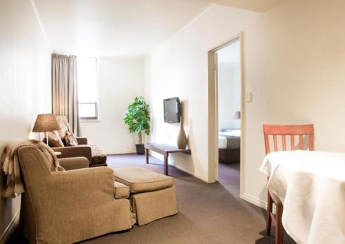 a hotel room with a bed and a living room at The Richmond Hotel - Adelaide in Adelaide