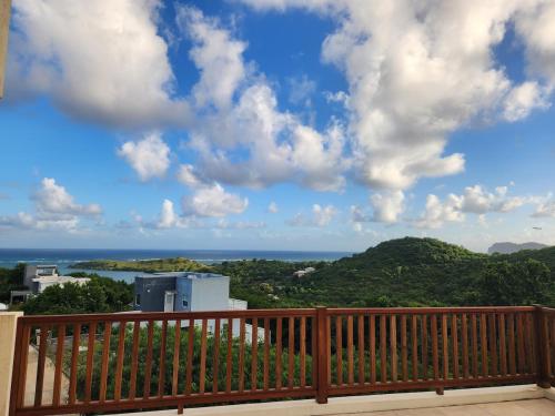 a view of the ocean from a balcony at Setsuna, Luxury Oceanic View Villa Near Airport in Vieux Fort