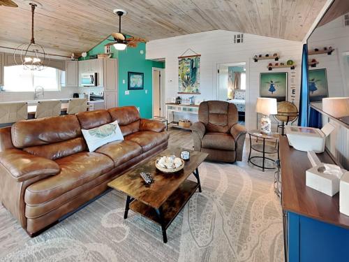 a living room with a couch and a table at Sand Piper in Rockport