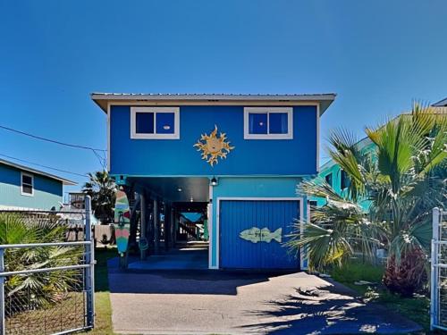 a blue house with a blue garage at Sand Piper in Rockport