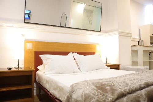 a bedroom with a bed with a mirror on the wall at MIDIS - Local Accommodation in Lisbon