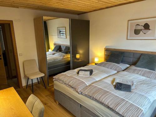a bedroom with a large bed with a mirror at Apartment in Saalfelden near Ski Slopes in Saalfelden am Steinernen Meer