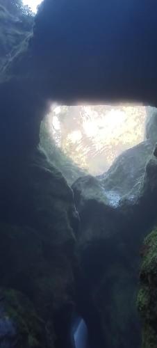 a view of a river from inside a cave at Gringo Petes Too in Fortuna
