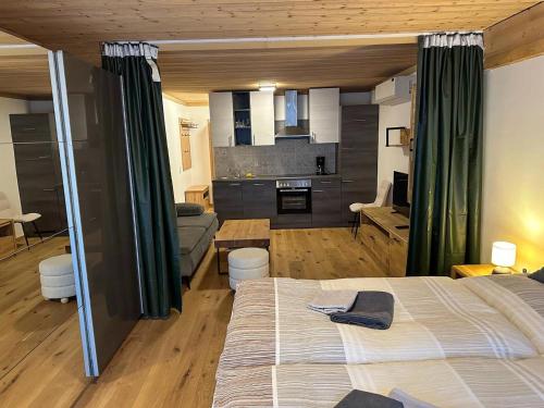 a bedroom with a bed and a living room at Apartment in Saalfelden near Ski Slopes in Saalfelden am Steinernen Meer