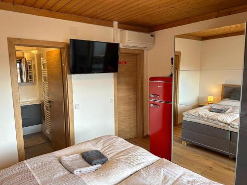 a room with two beds and a red refrigerator at Double room in Saalfelden near Ski Slopes in Saalfelden am Steinernen Meer
