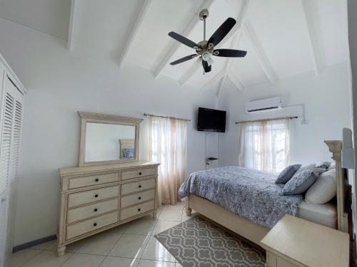 a bedroom with a bed and a ceiling fan at Grace's Place in Sapphire