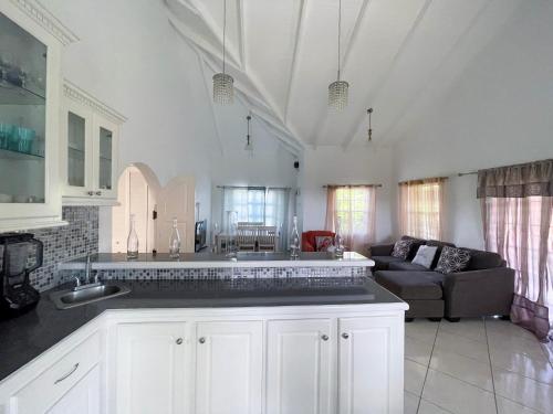 a kitchen and living room with a couch at Grace's Place in Sapphire