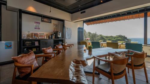 a dining room with a long table and chairs at Nishiizu Koyoi in Numazu