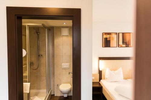 a bathroom with a shower and a toilet and a sink at A Casa Kristall in Sölden