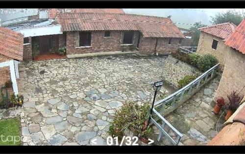 a building with a stone courtyard with a house at D'Antaño in Duitama