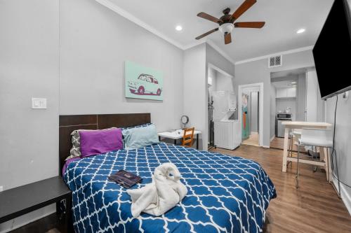 a room with a bed with a towel on it at Modern & Chic Montrose Studio - Prime Location & Free Parking in Houston