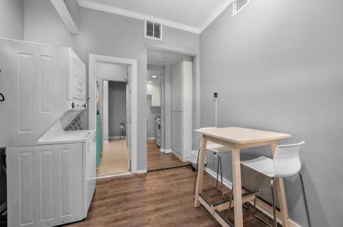 a kitchen with a table and chairs in a room at Modern & Chic Montrose Studio - Prime Location & Free Parking in Houston