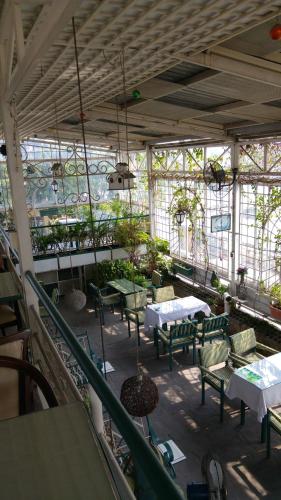 a patio with tables and chairs in a building at Khách sạn Minh Châu - Hòa Hưng in Ho Chi Minh City