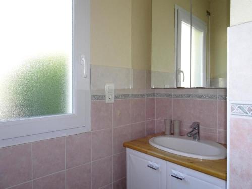 a bathroom with a sink and a mirror at Holiday Home by Kerleven Beach, France in La Forêt-Fouesnant